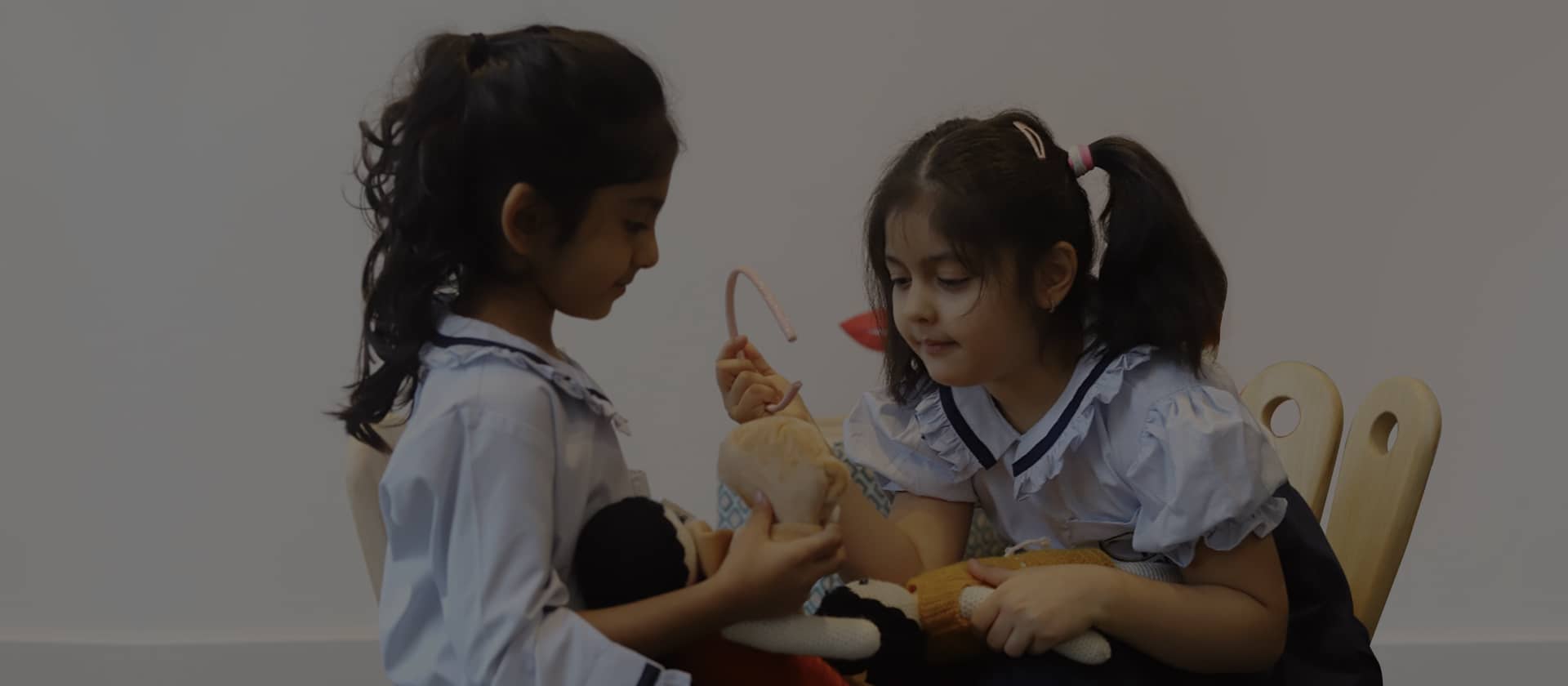 Girls playing with dolls